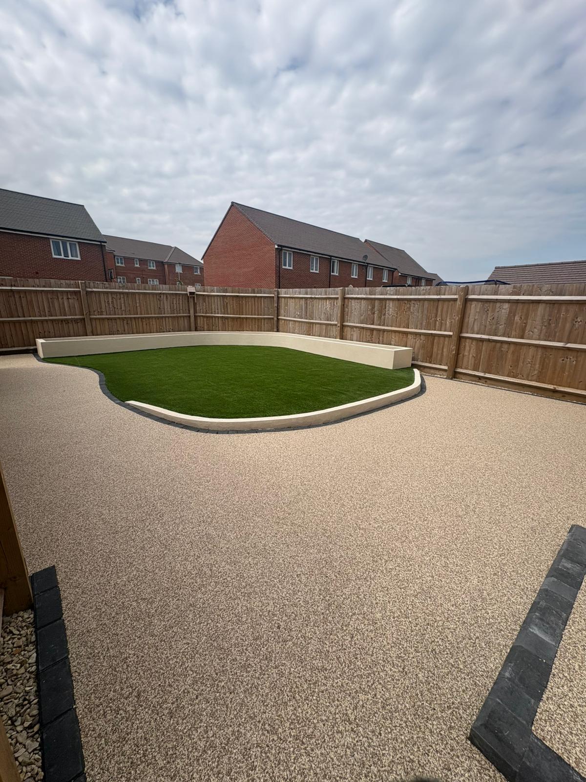 complete garden transformation resin with black paved border and artificial grass